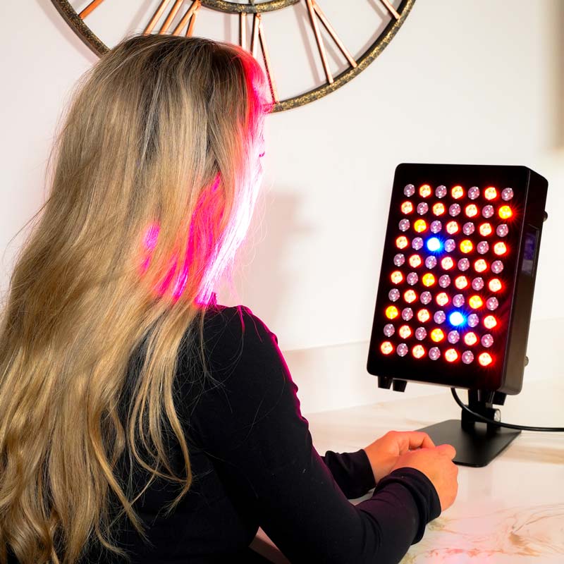 Lady sat in front of red light panel