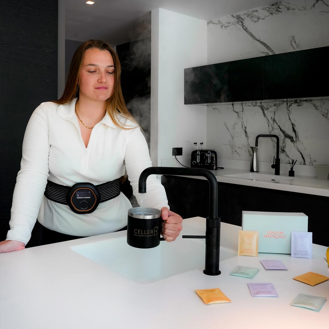 Women filling up mug with hot water tap