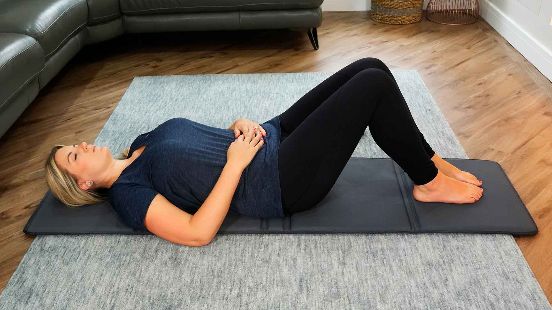 Lady laying down on CELLER8 PEMF mat