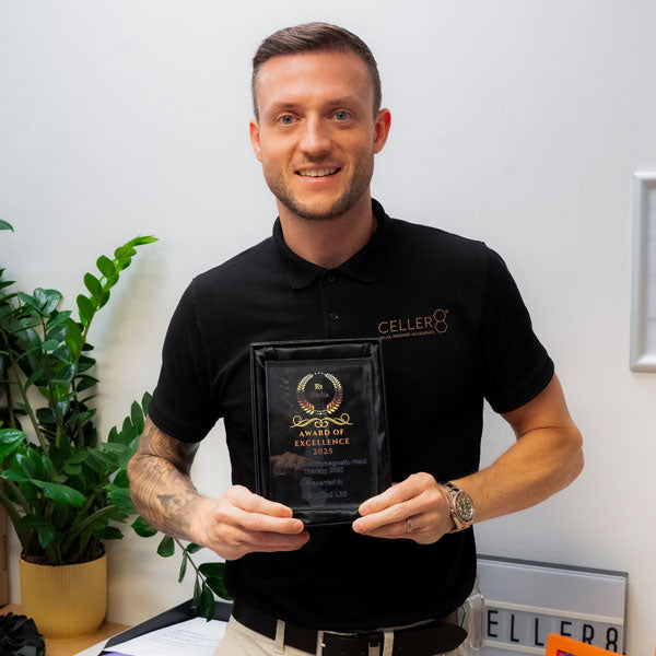 Andy holding Award for Excellence 2025, Pulsed Electromagnetic Field Therapy by E2 Media